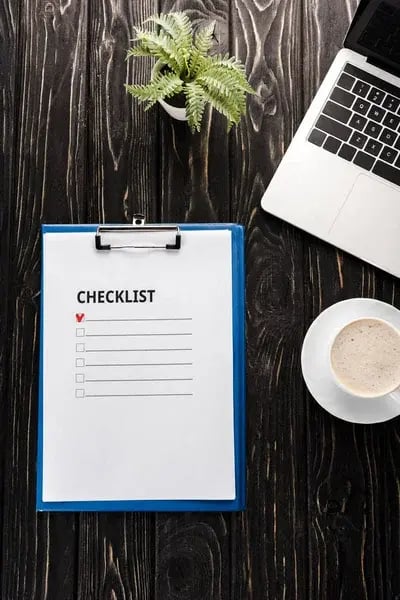 depositphotos_317633332-stock-photo-top-view-clipboard-checklist-laptop